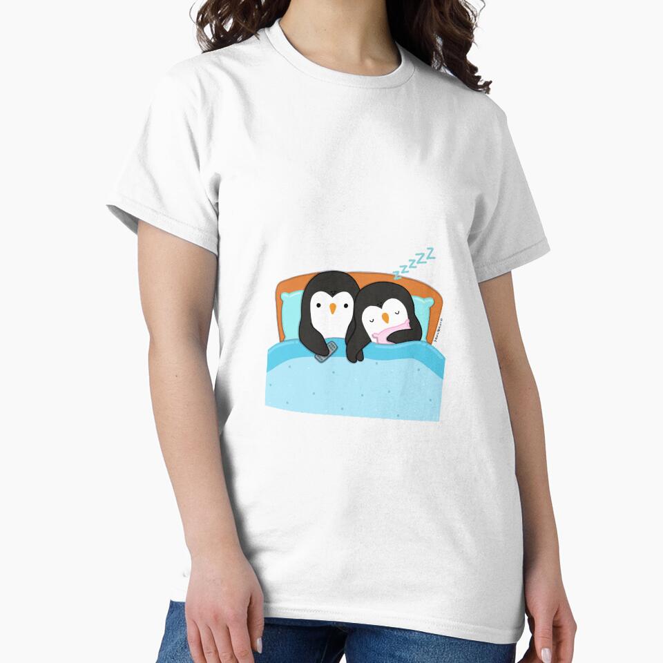 Couple of penguins watching tv in the bed before sleeping by julianamotzko