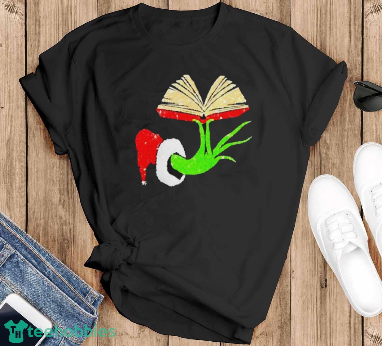 The Grinch hand holding a book Christmas shirt