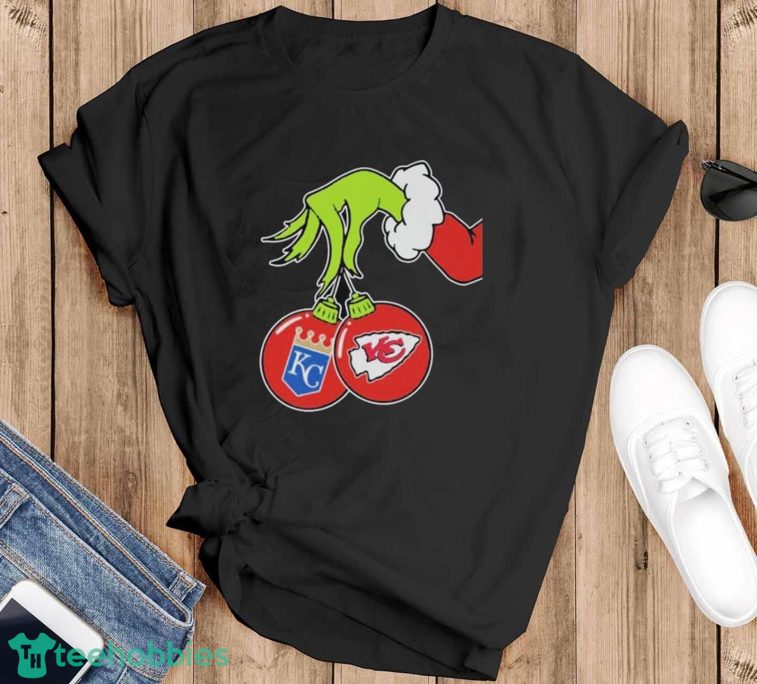 The Grinch Hand holding ornament Kansas City Royals and Chiefs logo Christmas shirt